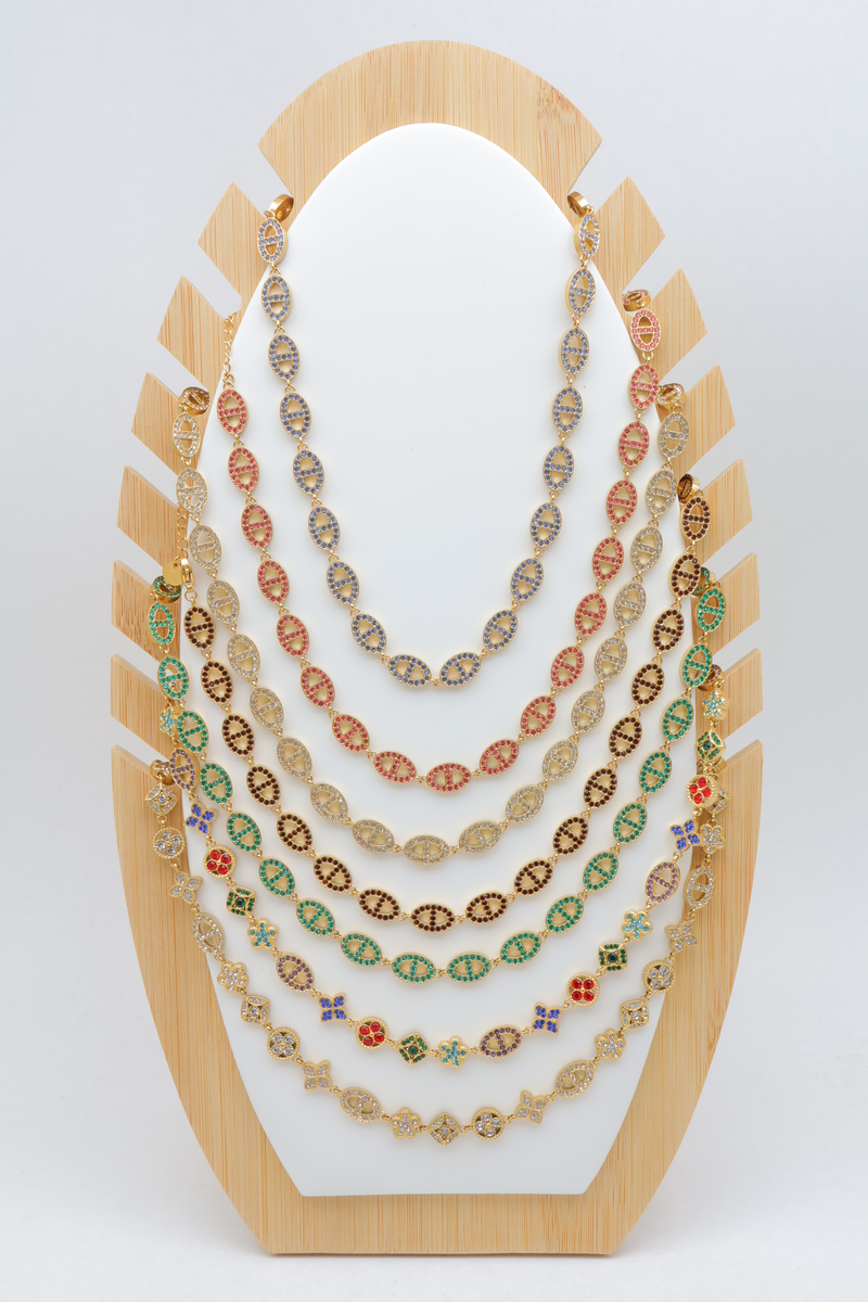 Lot de 7 colliers en acier inoxydable à strass et motifs maille marine et trèfle sur présentoir en bois — Multicolore