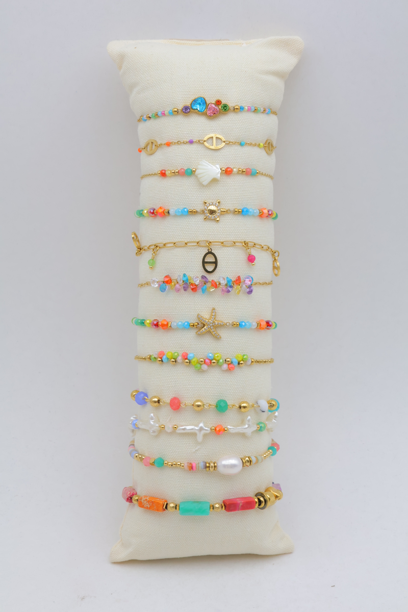 Set of 12 multi-tone pearl bracelets on cushion display