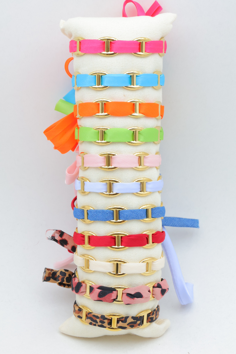 Set of 12 multi-tone pearl bracelets on cushion display