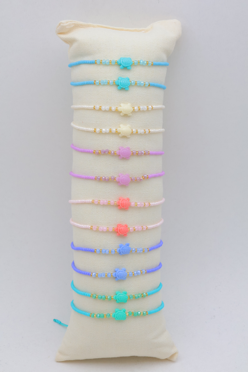 Set of 12 small cushions, each containing a set of 3 matching stainless steel bracelets, with a wooden tray — Multicolor