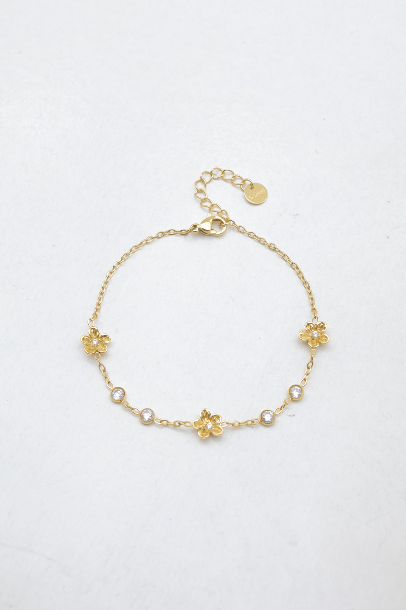 Edelstahl-kettenarmband mit blumenmustern und eingestreuten runden strasssteinen